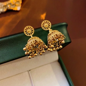 Gold plated vintage Jhumka tassel earrings with bell-shaped hollow carvings on jewelry box