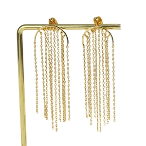 Elegant 18K gold plated tassel earrings with crescent moon curve on a display stand