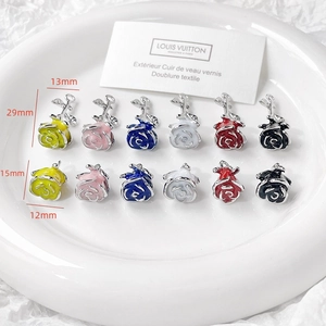 Detail view of multicolored vintage rose charms in various sizes for DIY jewelry making