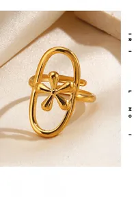 Detailed view of an oval gold-plated ring featuring a delicate five-petal flower on satin