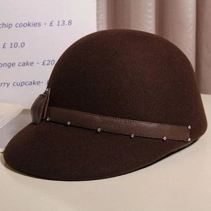 Detailed view of dark brown wool felt equestrian hat with rhinestone leather strap and bow