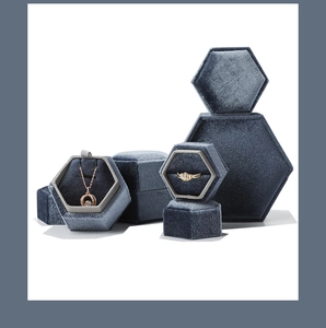 Macro shot of hexagonal velvet jewelry boxes in deep blue for rings and necklaces
