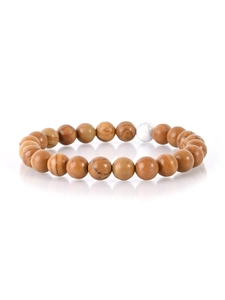 Close-up of beaded bracelet featuring brown wood grain stones and a white turquoise accent