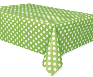 Detail of green plastic tablecloth with white polka dots for birthday parties