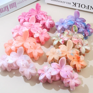 Detail showing various marble pattern flower hair claws in pink, purple, and orange colors