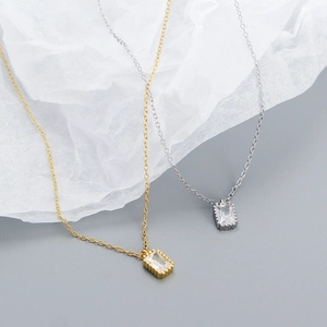 Detailed close-up of gold and silver S925 necklaces with rectangular zircon pendants