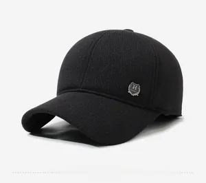 Detail view of winter woolen baseball cap with ear protection and silver metal badge