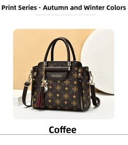 Detail of coffee brown FOSIDIRI monogram handbag with cat charm and burgundy tassel