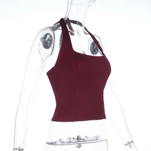 Side view detail of red slim fit halter top on mannequin showing fabric texture and slit