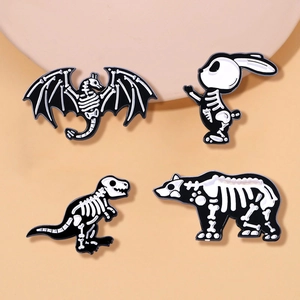 Detail view of 4-piece skeleton animal enamel pins featuring dragon, rabbit, and bear bones