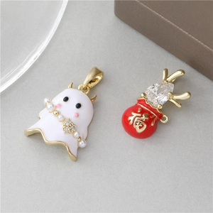 Close-up of mother-of-pearl pendant earrings with enamel and pearl detailing
