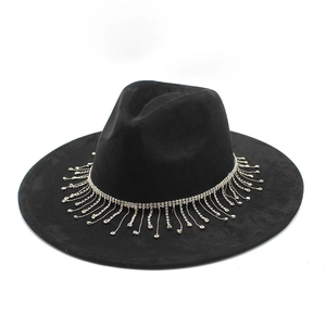 Close-up of sparkling silver rhinestone tassels on a black wide-brim suede bridal hat