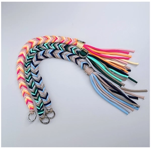 Close-up of three colorful hand-woven nylon straps with sturdy silver metal ring buckles