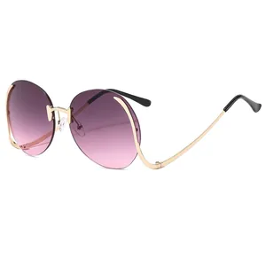 Oversized rimless round sunglasses with gold metal frames and purple gradient lenses