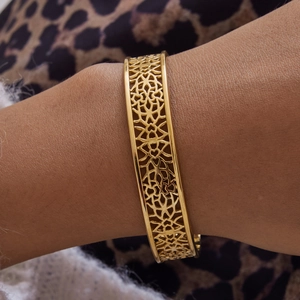 Detail of 18K gold stainless steel lace open bangle with intricate mandala cutout patterns