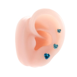 Three blue heart zircon titanium steel stud earrings on a silicone ear display model