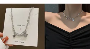 Double-layered silver necklace featuring solid and pavé star pendants in hip-hop style