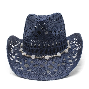 Close-up of dark blue straw cowboy hat with hollow weaving and heart bead trim