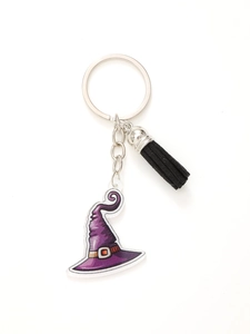 Detail of purple acrylic witch hat charm with black tassel on a metal keychain