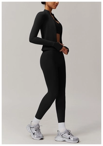 Detail of black high-stretch yoga set with thumbhole sleeves and high waist leggings