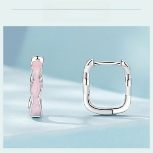 Detail view of s925 silver hoop earrings with pink wavy enamel finish and zircon accents