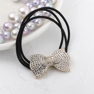 Élastique à cheveux avec nœud en strass étincelant et base dorée sur bande noire