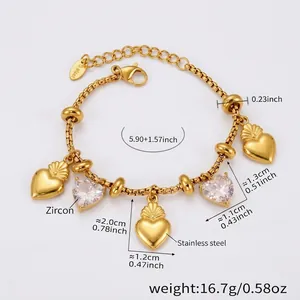Detail shot of golden snake chain bracelet with heart pendants and zircon stones