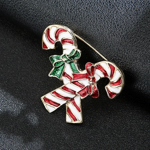 Detailed view of Christmas candy cane brooch with colorful enamel on dark leather