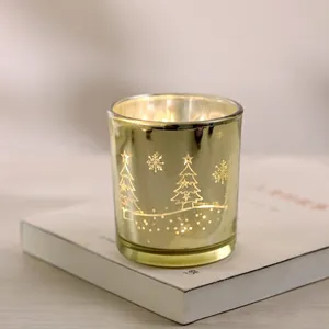 Detail of a gold plated Christmas candle holder with star and tree patterns