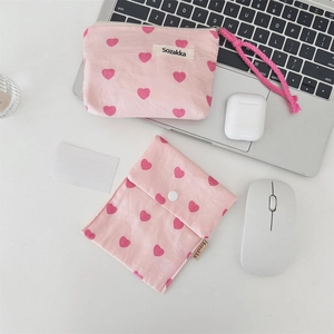 Detailed set of pink heart-patterned canvas storage bags on an organized work desk
