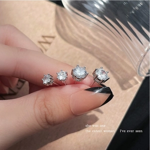 Sparkling zircon round stud earrings in four sizes shown in a silver-tone metal finish