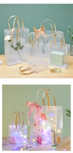 Frosted PP gift bags in various sizes with khaki handles and decorative LED light strings
