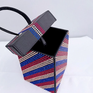 Close-up of a rhinestone square box handbag featuring red blue and gold stripes
