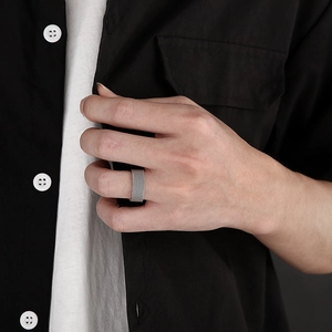 Classic silver mesh textured titanium steel ring shown on a male hand with a black shirt