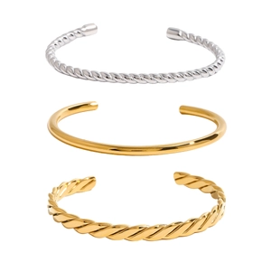 Three-piece 18K gold plated stainless steel open bangle set with varied textures and finishes