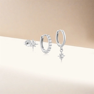 Close-up of S925 sterling silver star and pavé zircon earring set in a three-piece display
