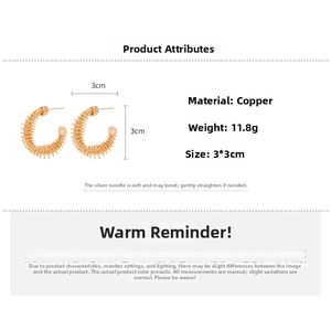 Detailed view of gold plated C-shaped twisted earrings with copper wire wrap texture