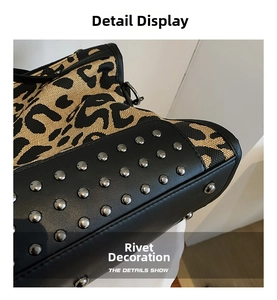 Detail view of leopard print canvas tote with black leather trim and silver metal rivets