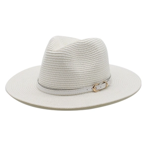 Detail of white woven sun hat with synthetic leather band and golden metal eyelets