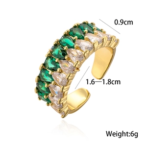 Detail view of gold ring with pear-cut green and clear stones showing 0.9cm width