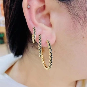 Three-piece set of gold twisted C-shape hoop earrings with black micro-pave stones