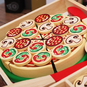 Close-up of wooden pretend play pizza set with assorted toppings on a round wooden tray