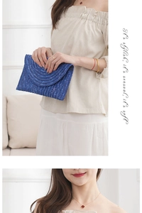 Detail of blue straw woven envelope clutch bag with textured semi-circle pattern