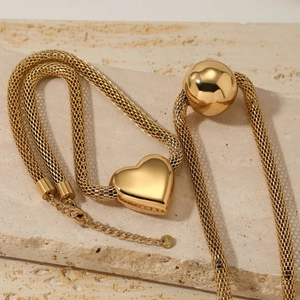 Golden stainless steel mesh chain necklace featuring hollow heart and sphere pendants
