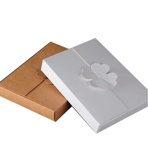 Flat rectangular paper gift boxes with four-leaf clover closure in white and kraft brown