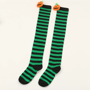 Detail of green and black striped Halloween over-knee socks with cute pumpkin charms