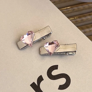Detail view of pink heart rhinestone hair clips with polished silver alloy finish