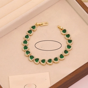 Detailed close-up of 18K gold plated bracelet with green heart-shaped zircon stones