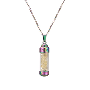 Macro detail of rainbow stainless steel perfume bottle pendant filled with yellow crystals