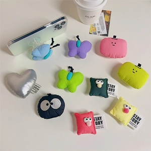 Close-up of cute plush retractable phone grips in various colorful cartoon shapes